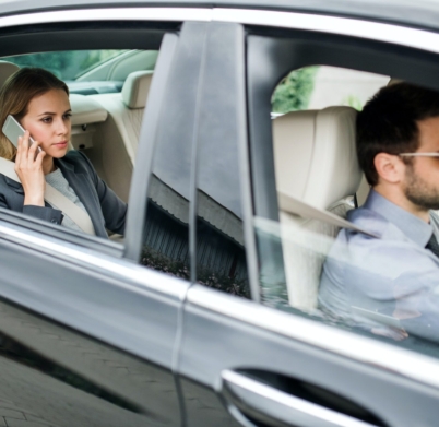 businesswoman-sitting-on-back-seat-in-taxi-car-talking-on-the-phone-