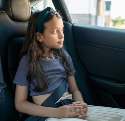 little-girl-sitting-on-backseat-of-new-comfortable-car